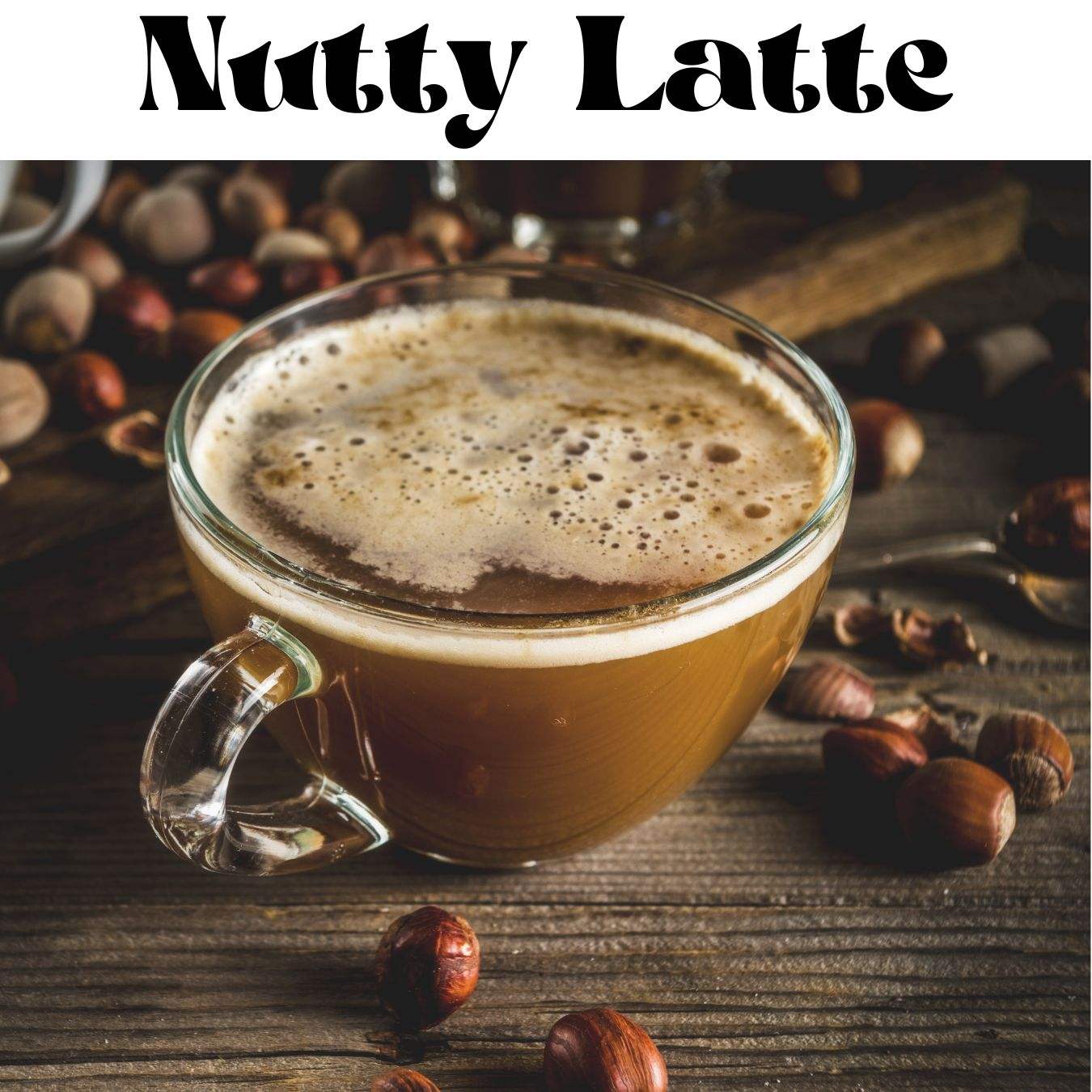 A cup of latte with roasted hazelnuts scattered around on a wooden surface.