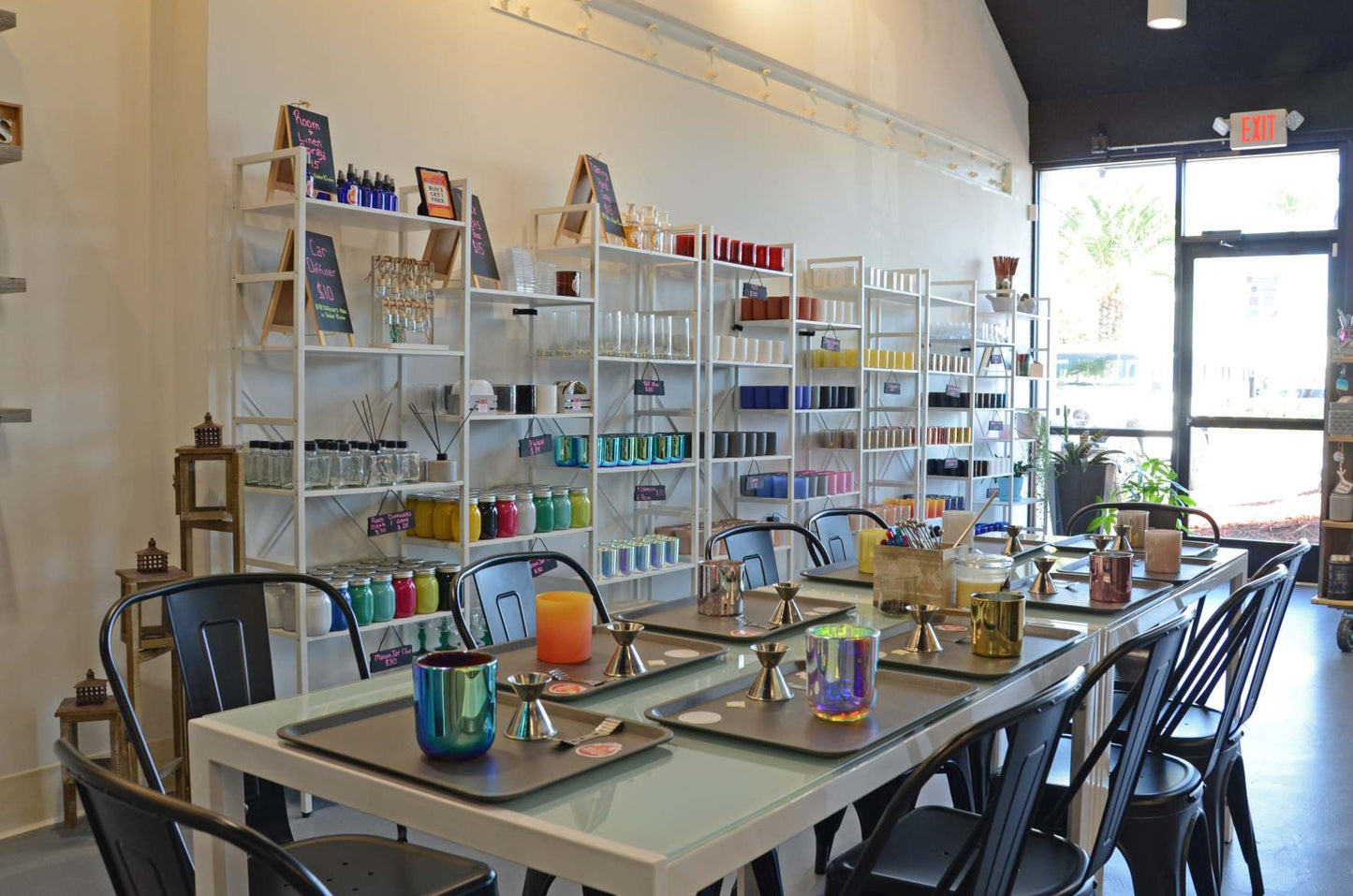 Interior view of Wick N Twisted a candle making store with shelves of fragrance oils and equipment for candle making.