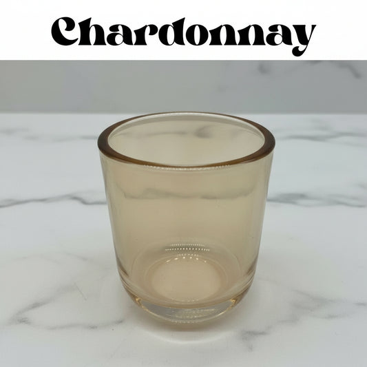 Clear glass tumbler on a marble surface with 'Chardonnay' text above.